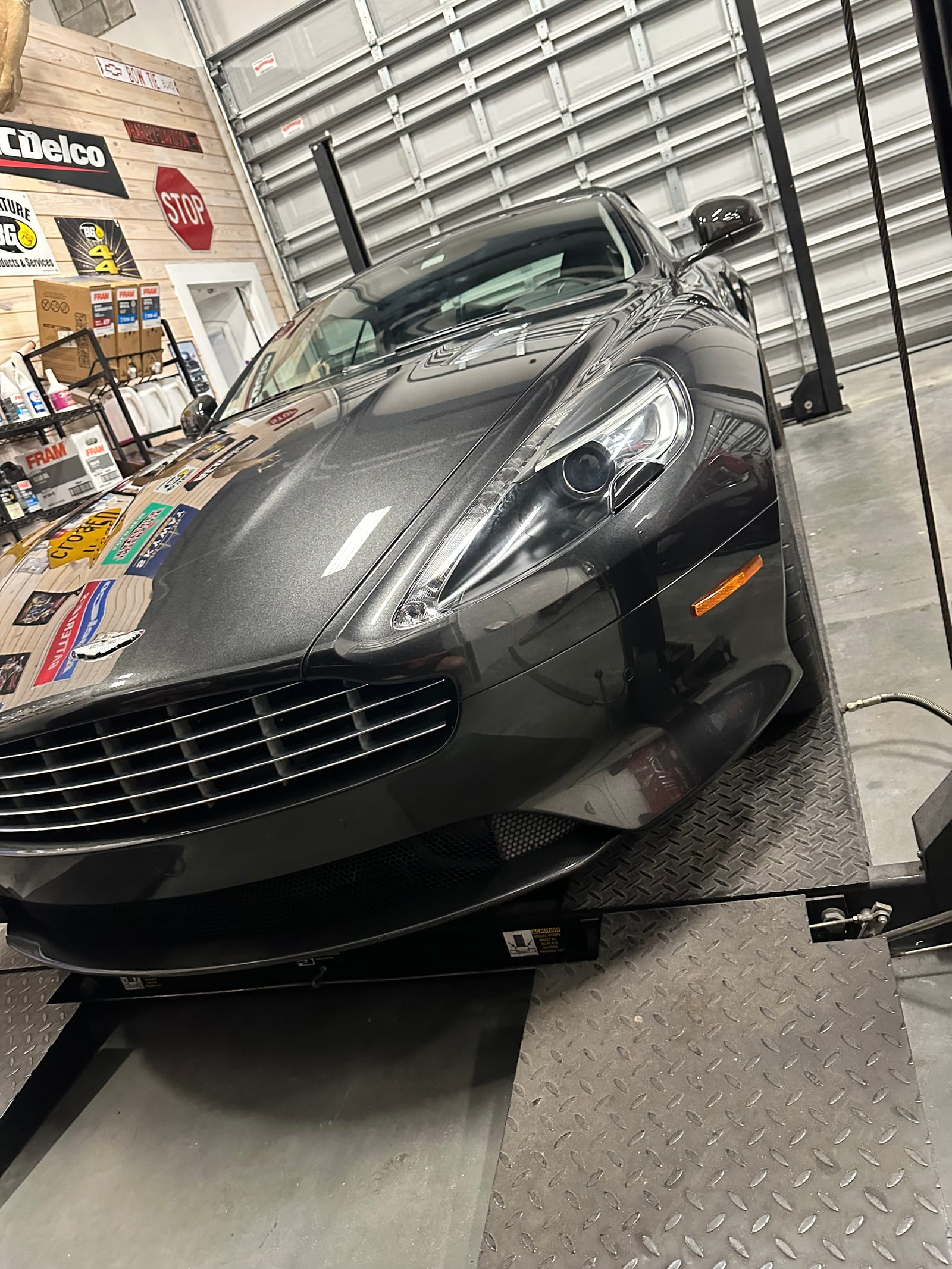 Aston Martin on a lift during a multi stage paint correction