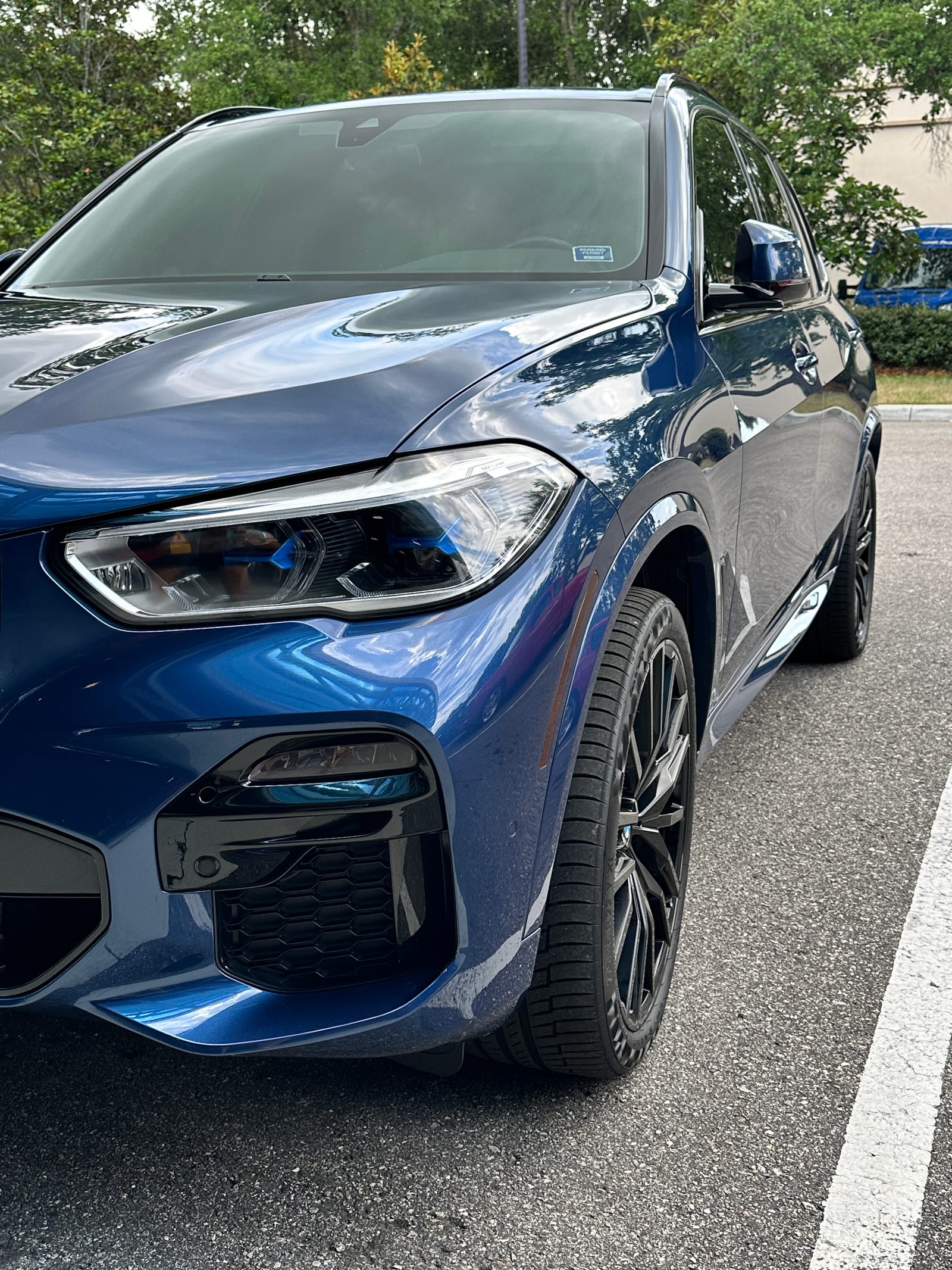 Blue BMW X5 with a ceramic coated finish holding a deep gloss