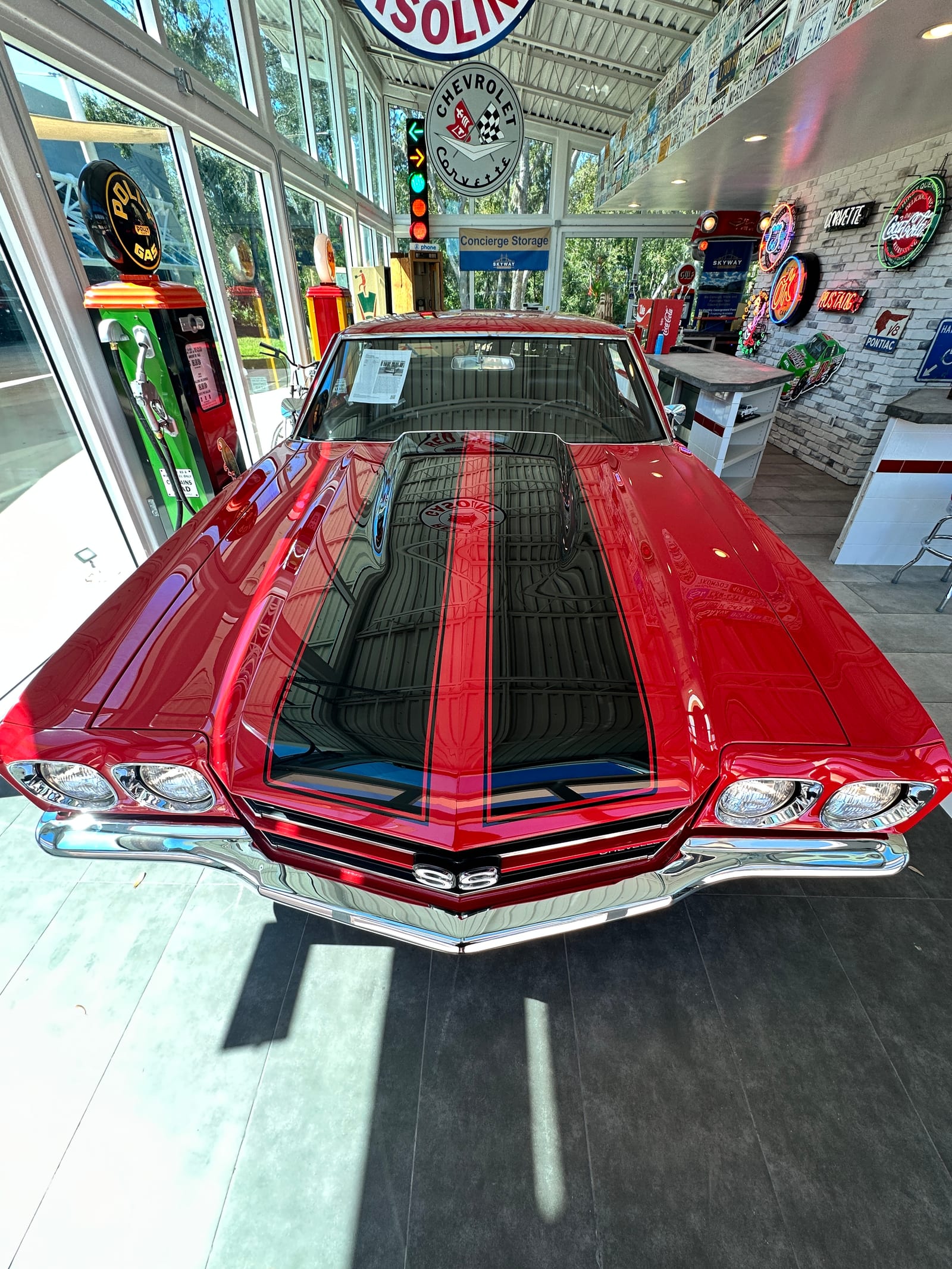 Red Chevrolet Chevelle SS in a showroom after paint correction