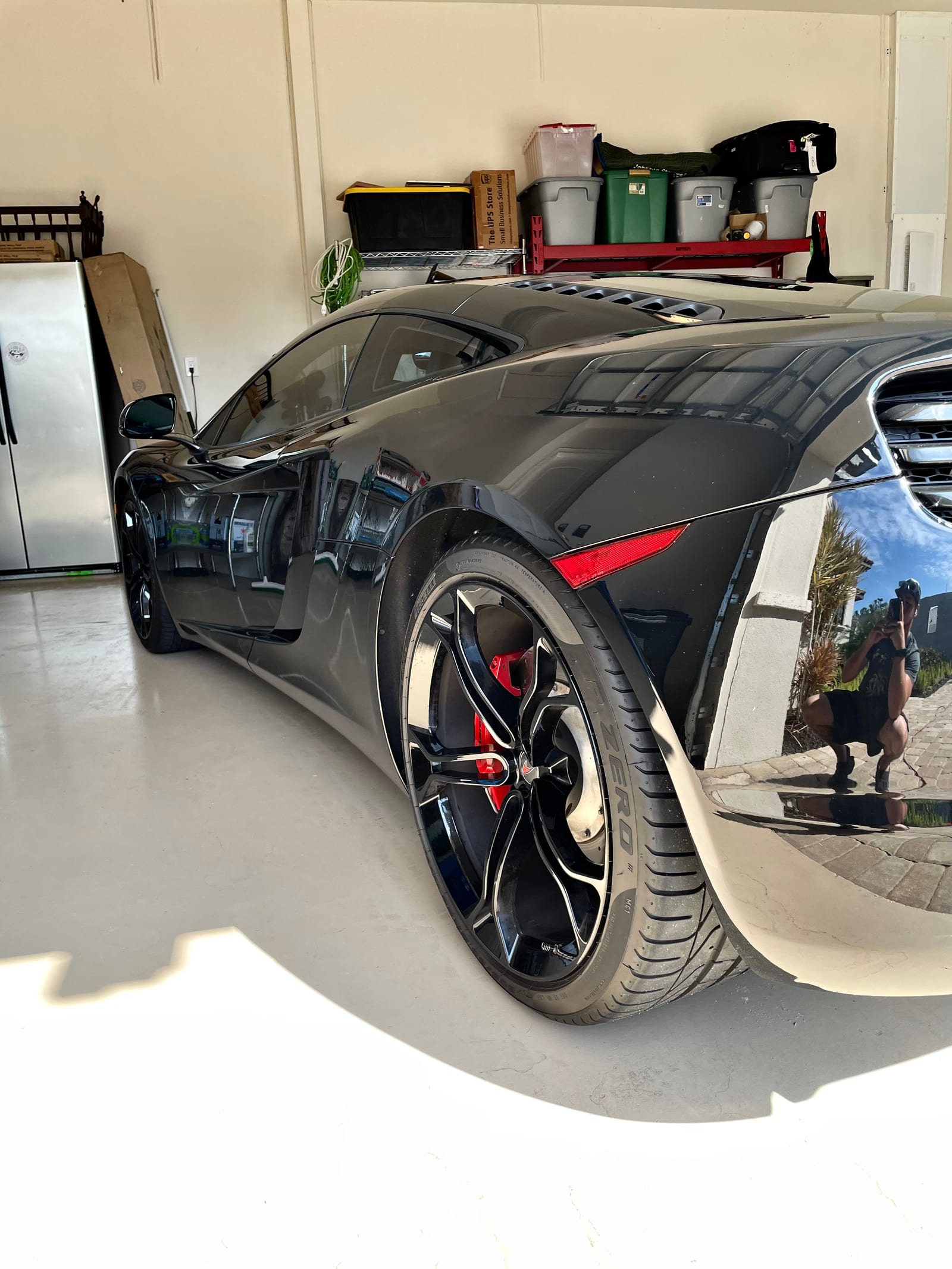 Black McLaren rear quarter and wheel after paint correction
